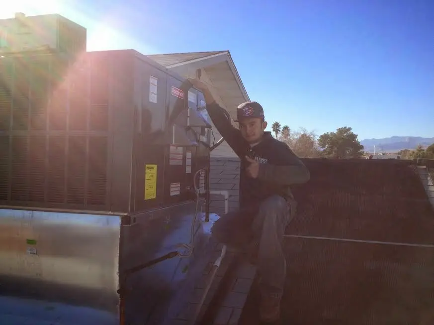 HVAC technician performing HVAC Inspection on a rooftop unit in Uniontown
